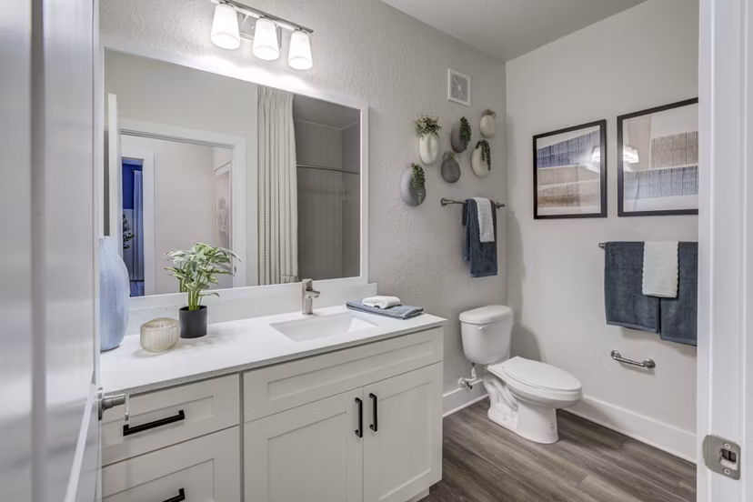 Modern bathroom featuring sleek fixtures and spacious vanity at Alton Serenoa Apartments
