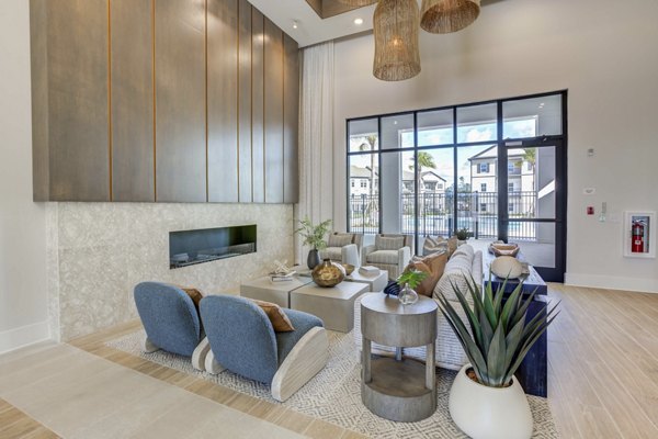 Modern clubhouse with elegant seating and fireplace at Alton Serenoa Apartments