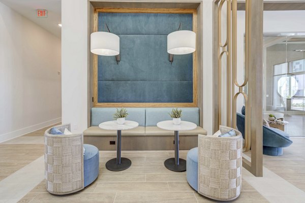 Clubhouse with modern seating and lighting at Alton Serenoa Apartments, a luxury living community