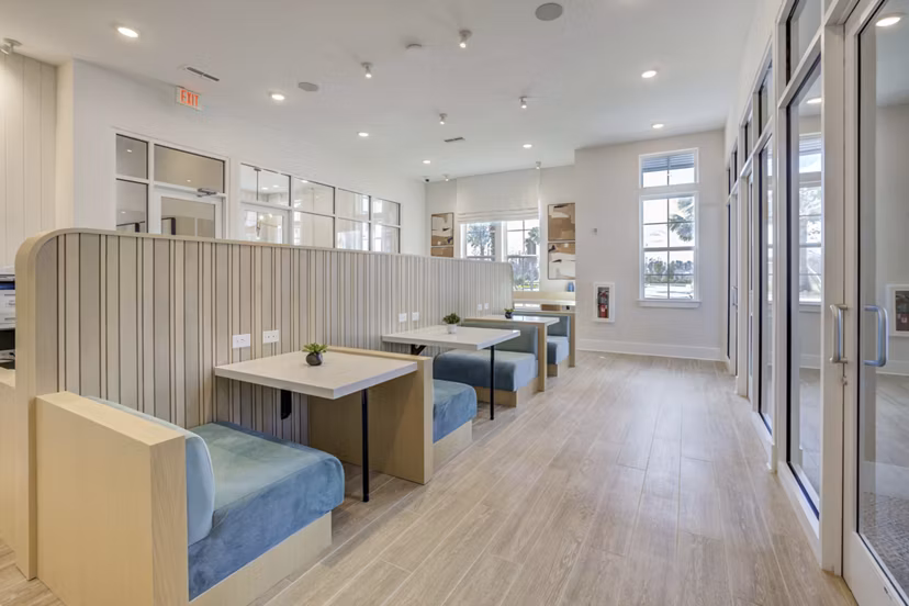Clubhouse featuring modern furnishings at Alton Serenoa Apartments, a Greystar luxury community