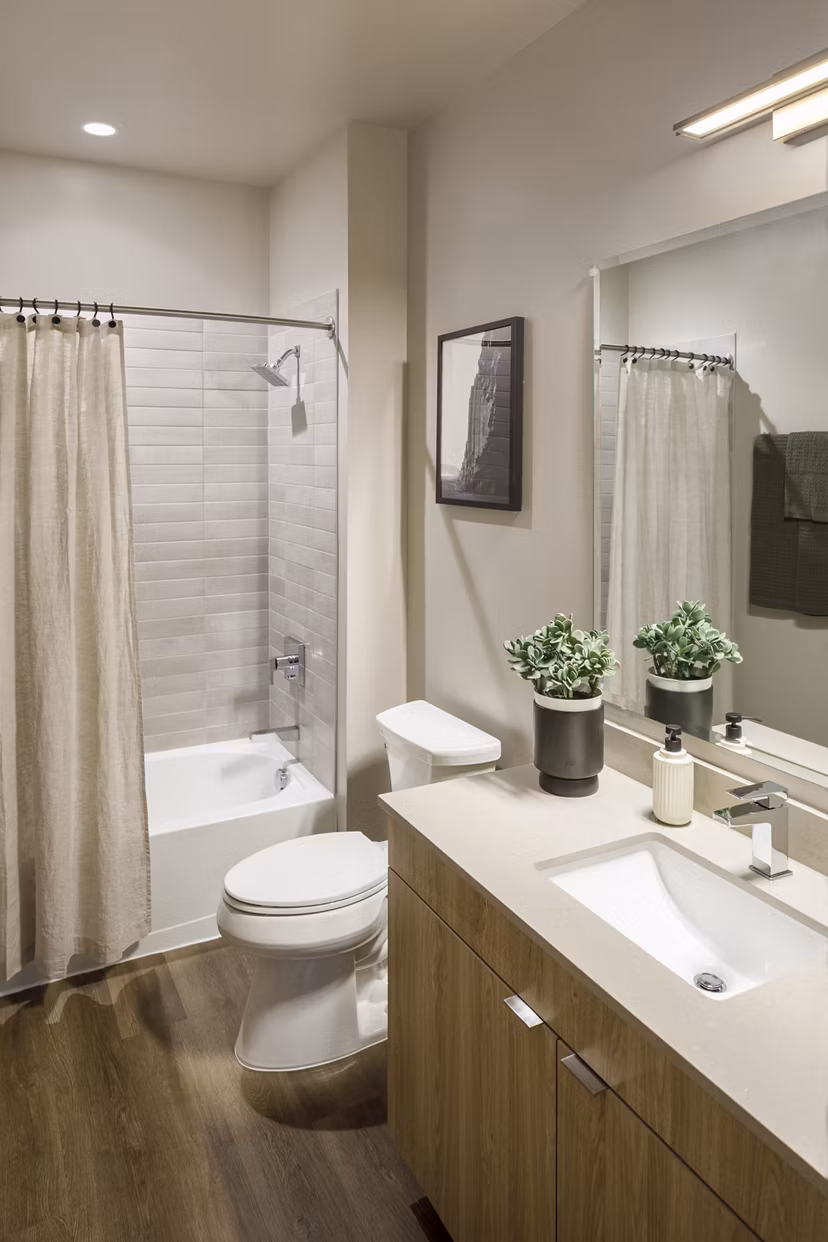 Modern bathroom with sleek fixtures and ample lighting in Atworth Apartments, luxury living by Greystar