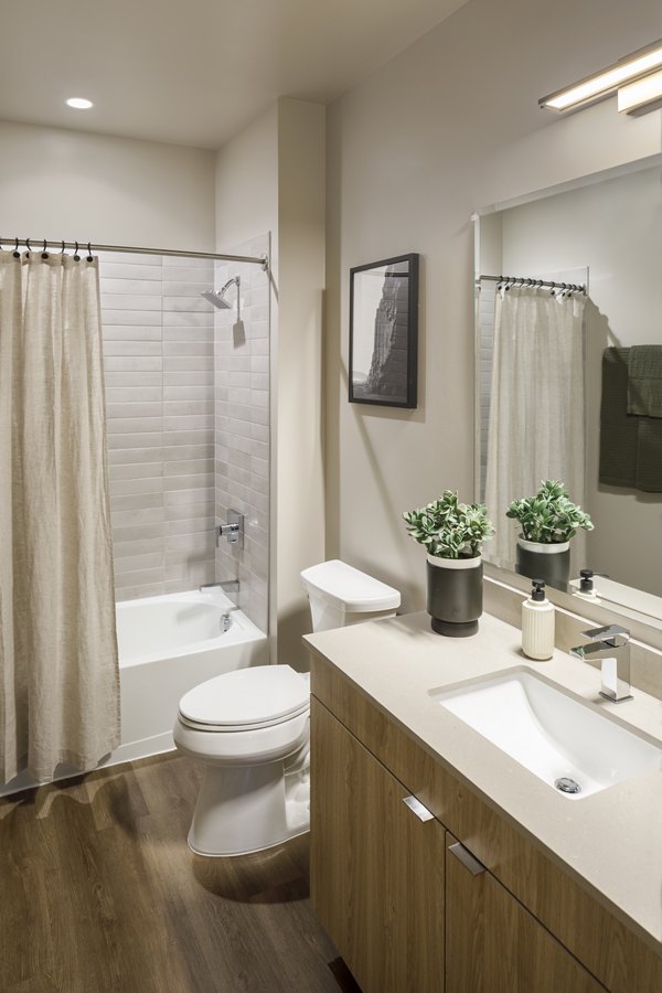 Modern bathroom with sleek fixtures and ample lighting in Atworth Apartments, luxury living by Greystar