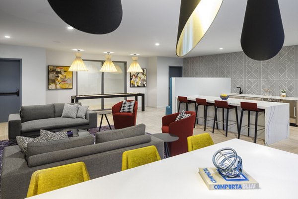 Modern clubhouse with cozy seating and communal workspaces at Atworth Apartments, a luxury community by Greystar
