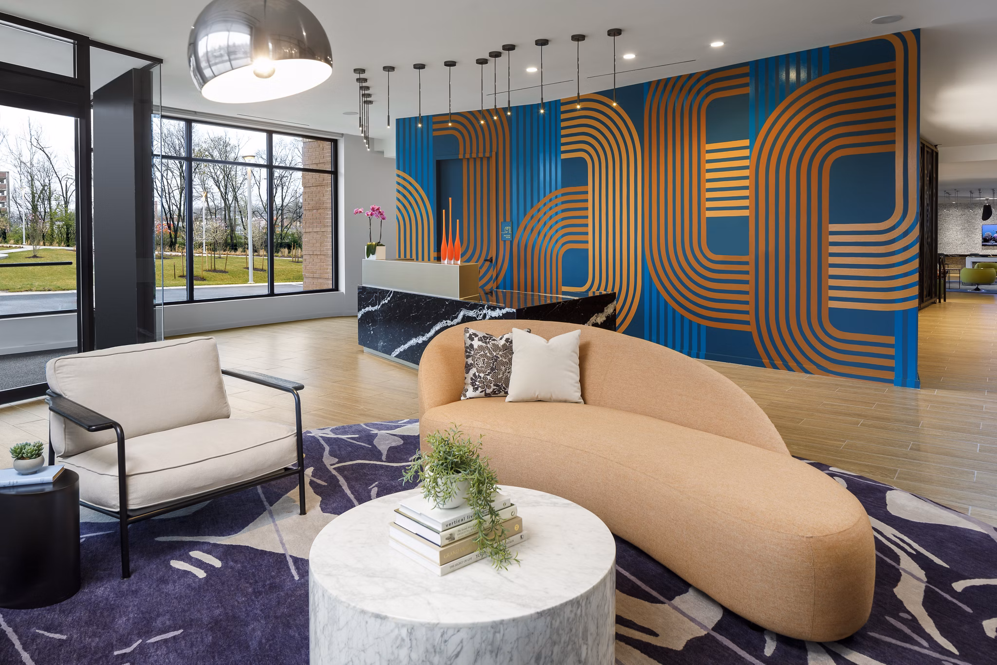 Clubhouse with modern design and comfortable seating at Atworth Apartments, ideal for social gatherings and relaxation