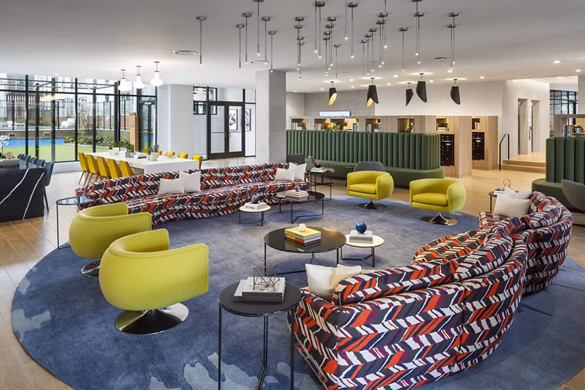 Modern clubhouse with vibrant seating and pool table at Atworth Apartments