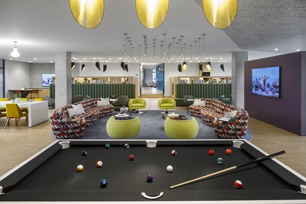 Clubhouse featuring modern decor and comfortable seating at Atworth Apartments, a Greystar luxury community