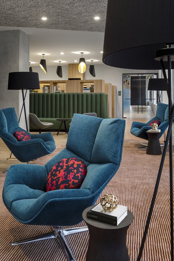 Clubhouse featuring modern design and cozy seating at Atworth Apartments
