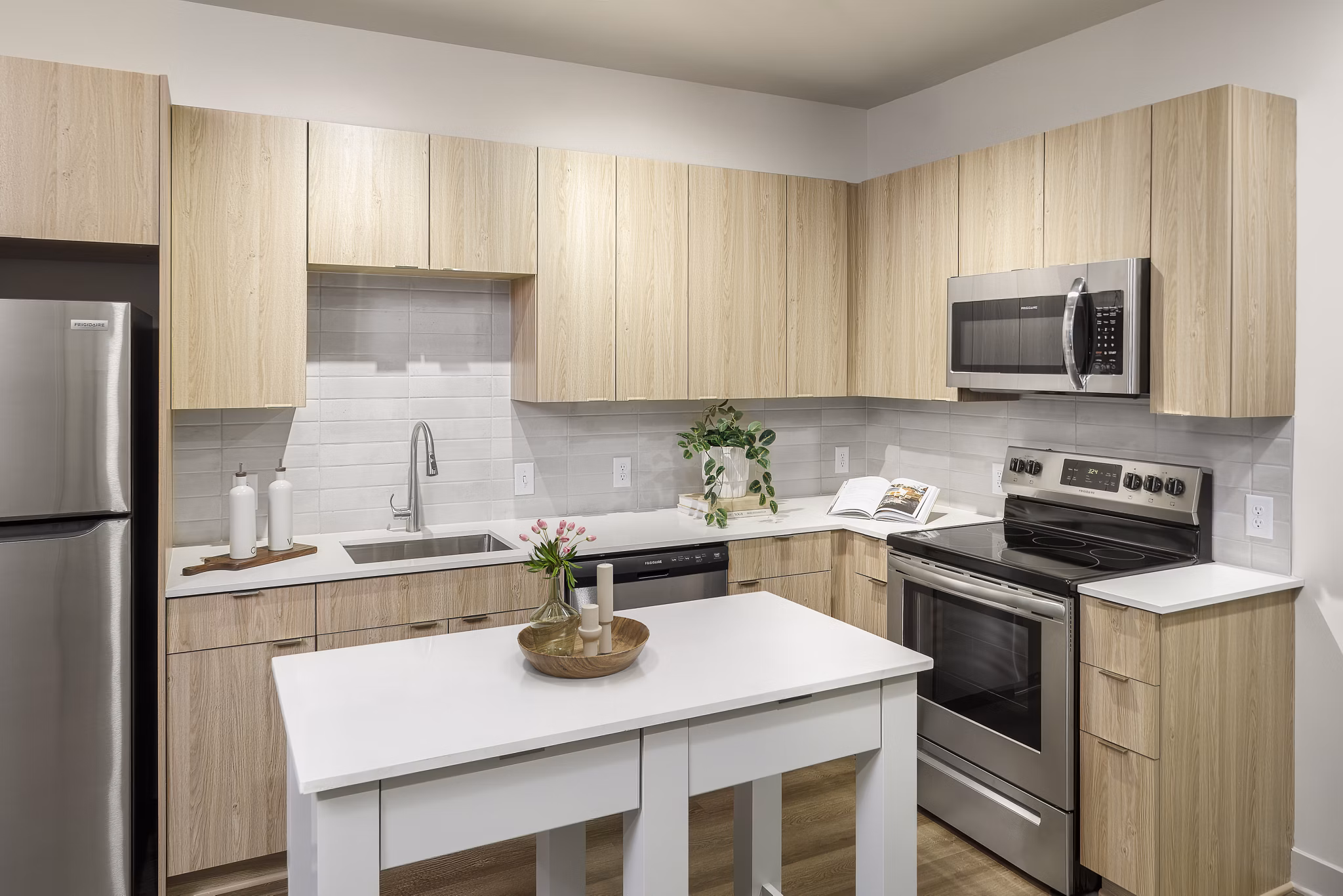 Modern kitchen with stainless steel appliances at Atworth Apartments