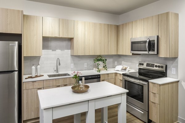 Modern kitchen with stainless steel appliances at Atworth Apartments