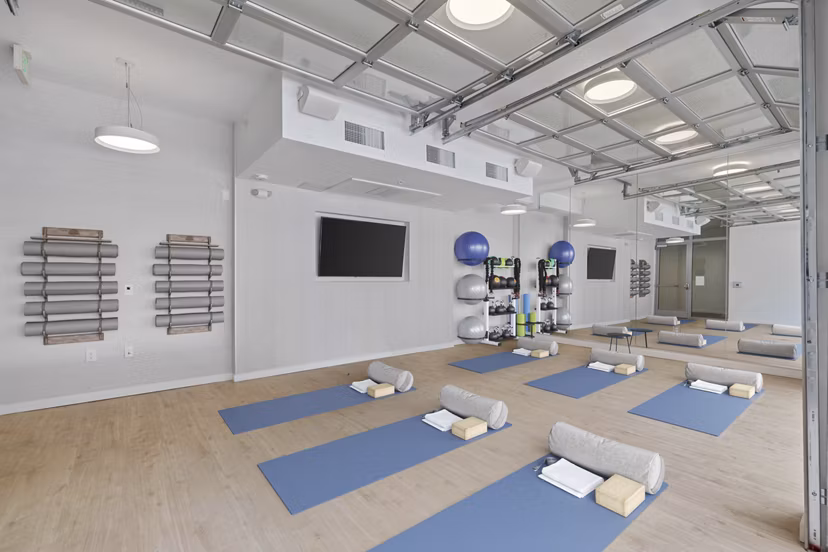Modern yoga/spin studio with natural lighting at Legacy at Fitz Apartments, promoting wellness and active lifestyle