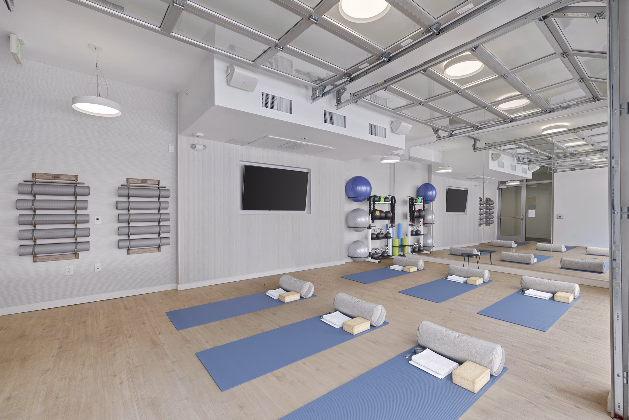 Modern yoga/spin studio with natural lighting at Legacy at Fitz Apartments, promoting wellness and active lifestyle