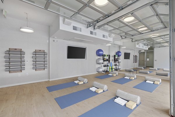 Modern yoga/spin studio with natural lighting at Legacy at Fitz Apartments, promoting wellness and active lifestyle