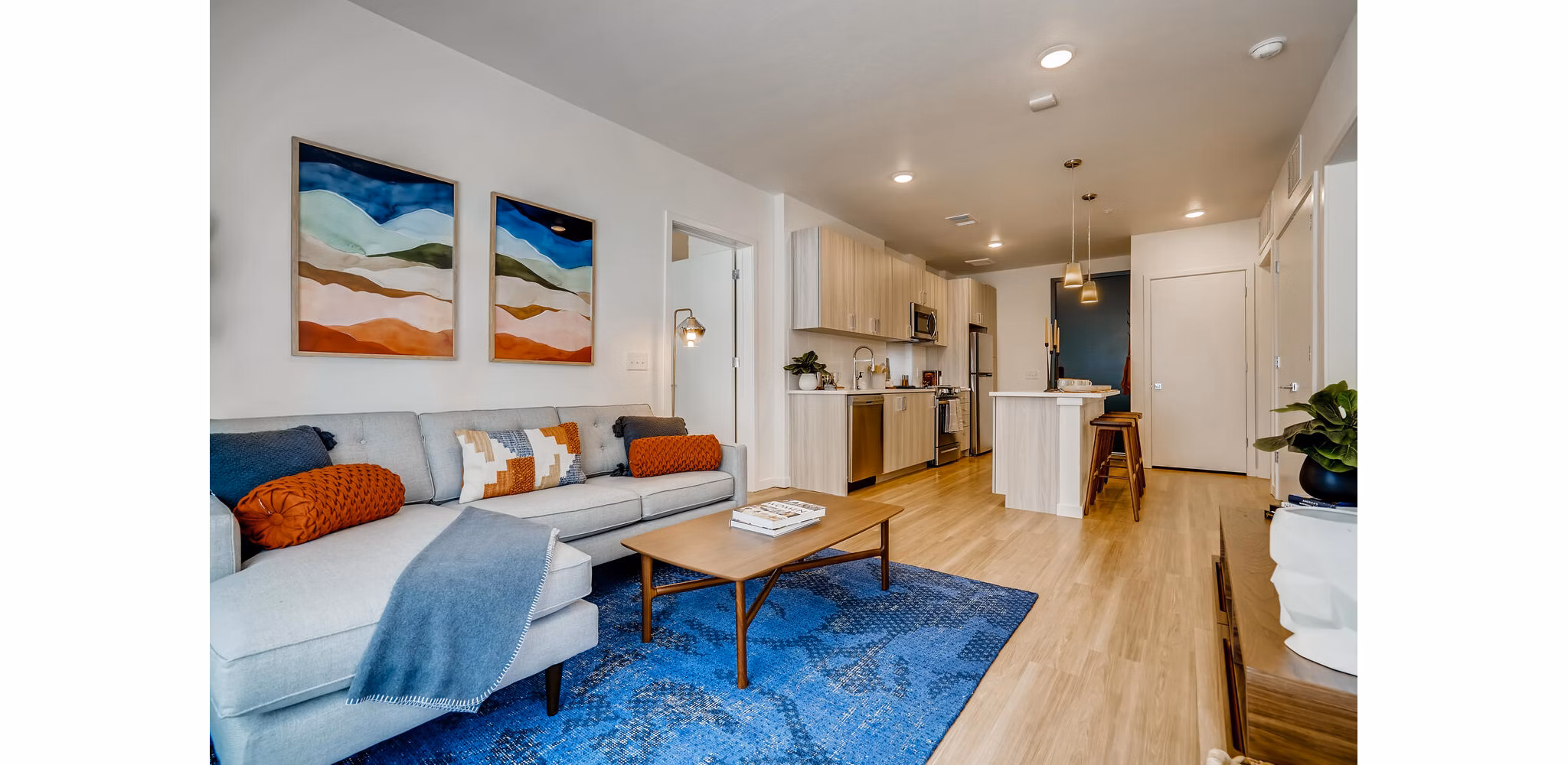 Modern living room with sleek furnishings and large windows at Legacy at Fitz Apartments