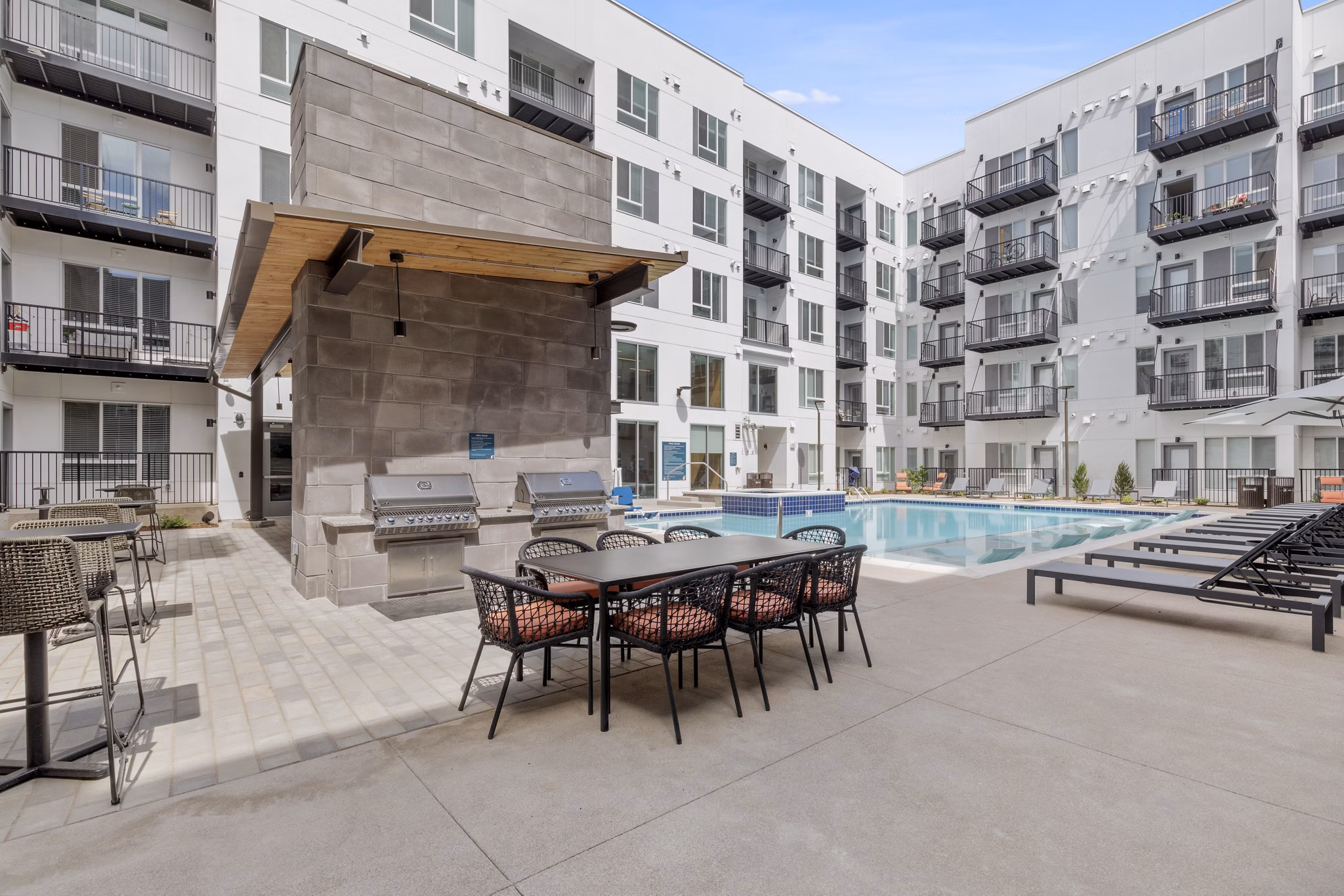 Outdoor grill area with seating at Legacy at Fitz Apartments, ideal for summer BBQs and gatherings