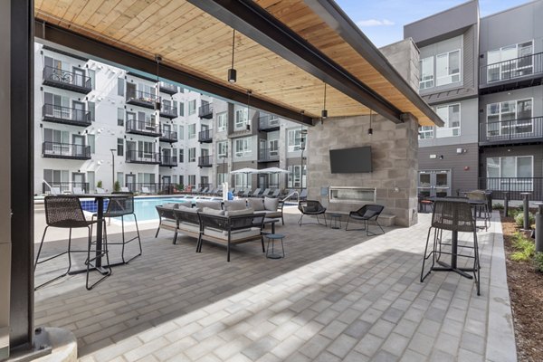 Relaxing patio with modern seating at Legacy at Fitz Apartments, ideal for enjoying outdoor moments