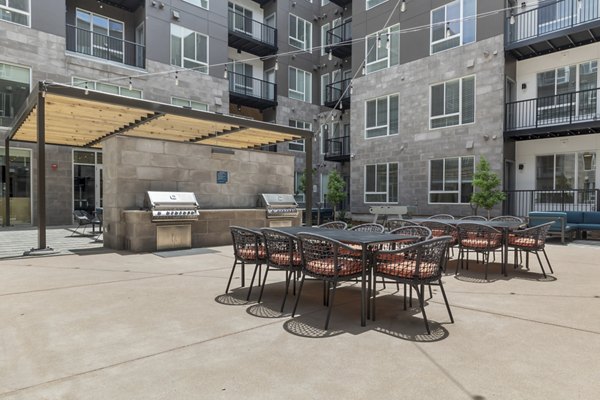 Legacy at Fitz Apartments: Outdoor grill area with seating, ideal for social gatherings and cooking, in a luxury community