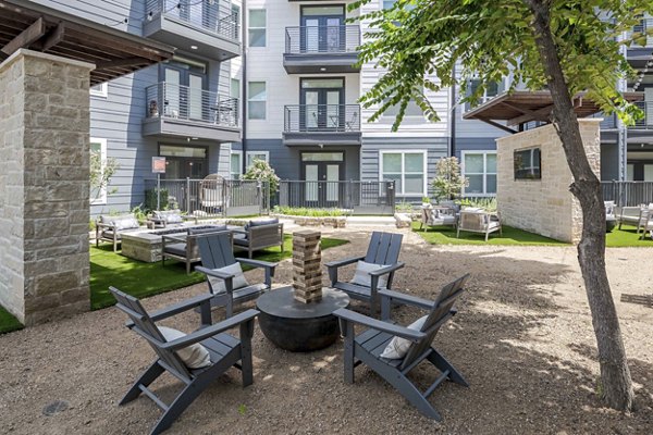 Courtyard with lush greenery and seating at The Grayson Apartments, a luxury community offering modern living spaces in a serene setting