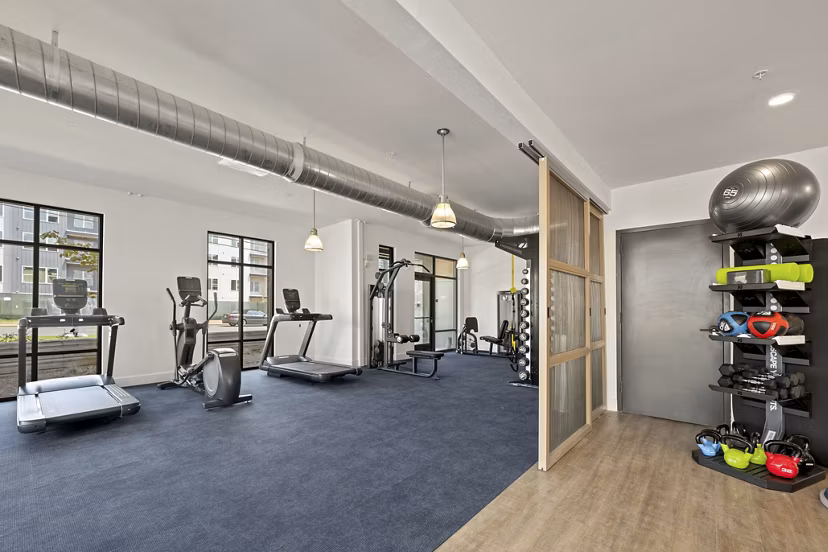 Fitness center at Bowery West Apartments featuring modern equipment and spacious workout areas