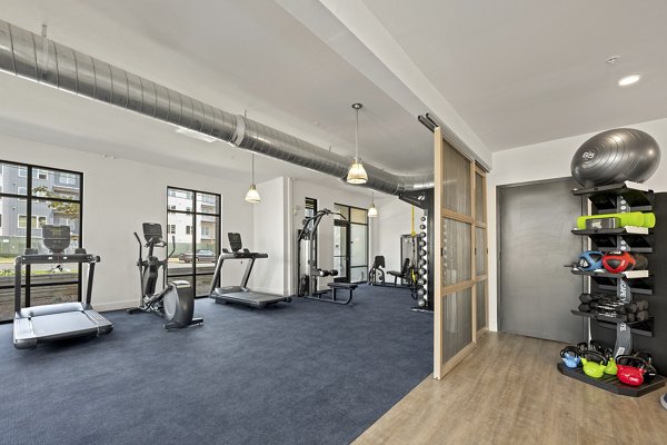 Fitness center at Bowery West Apartments featuring modern equipment and spacious workout areas