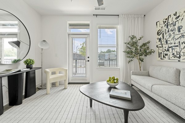 Living room designed for luxury at Bowery West Apartments featuring modern furnishings and open layout