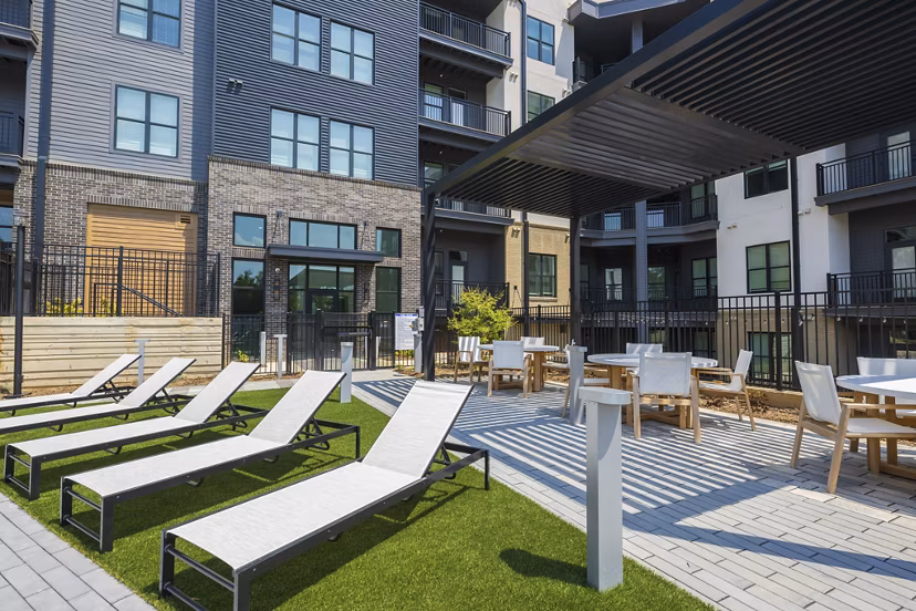 Patio with modern outdoor seating at Bowery West Apartments, perfect for relaxing and socializing in a luxury Greystar community