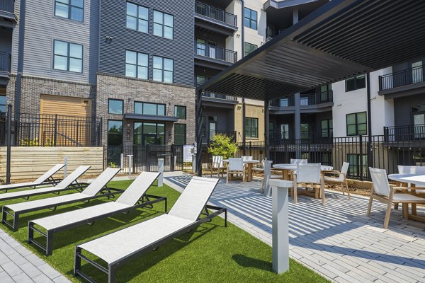 Patio with modern outdoor seating at Bowery West Apartments, perfect for relaxing and socializing in a luxury Greystar community