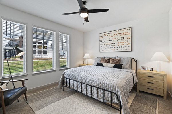Contemporary bedroom with designer furnishings at The Gabriel Apartments, offering a luxurious living experience