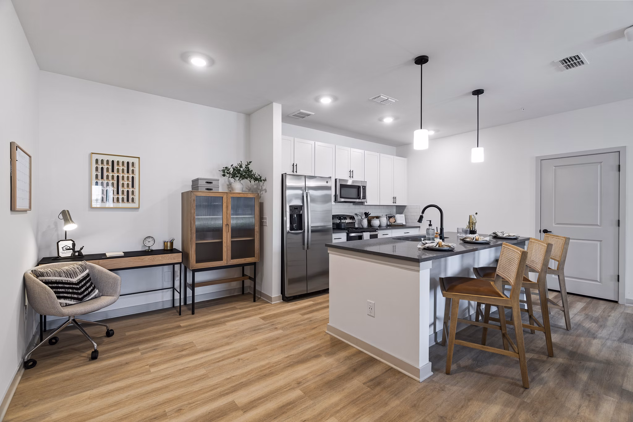 Modern kitchen with stainless steel appliances at The Gabriel Apartments luxury homes