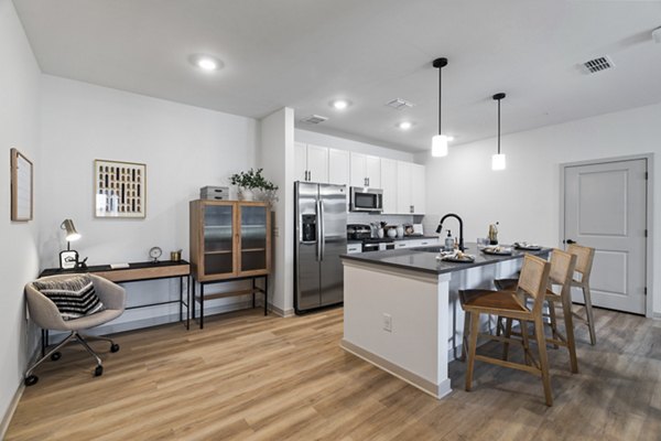Modern kitchen with stainless steel appliances at The Gabriel Apartments luxury homes