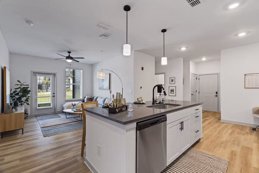 Modern kitchen featuring stainless steel appliances and quartz countertops at The Gabriel Apartments in this Greystar luxury community
