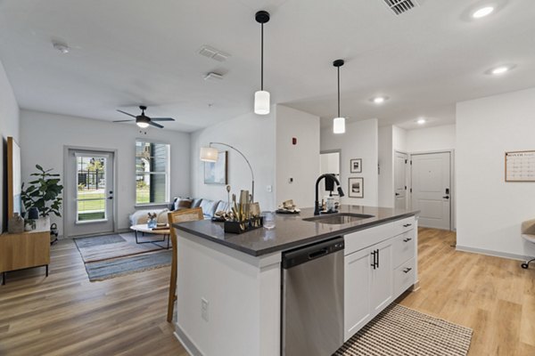 Modern kitchen featuring stainless steel appliances and quartz countertops at The Gabriel Apartments in this Greystar luxury community