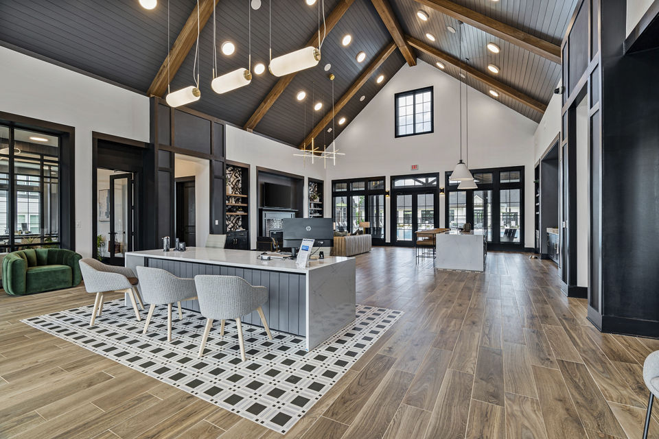 Living room featuring modern decor and large windows at The Gabriel Apartments