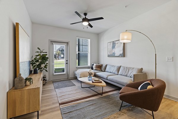 Luxury living room with modern decor and natural light at The Gabriel Apartments, Greystar community