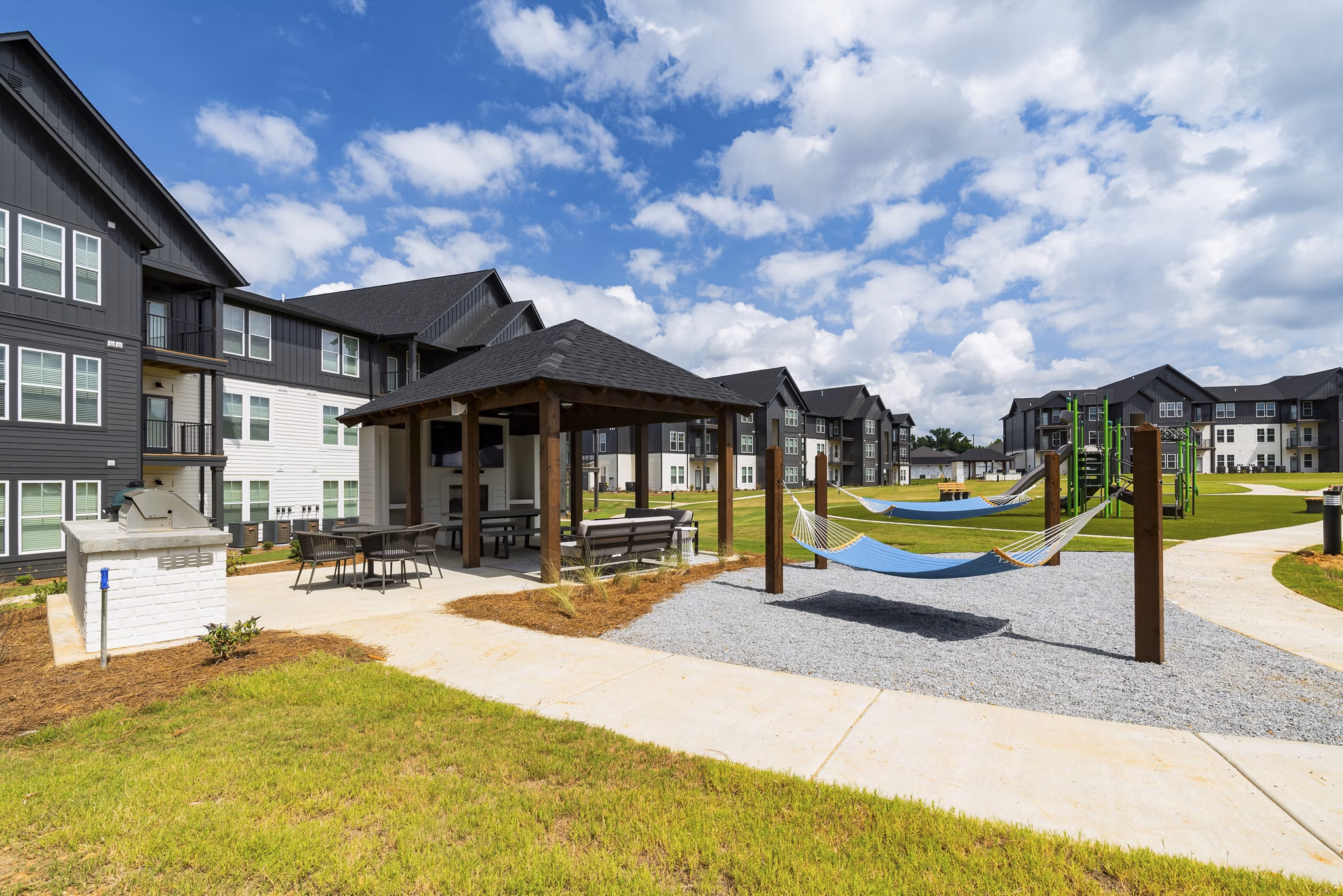 Chic patio with modern seating and greenery at The Gabriel Apartments, a luxury Greystar property