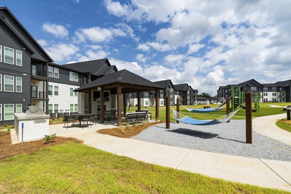 Chic patio with modern seating and greenery at The Gabriel Apartments, a luxury Greystar property