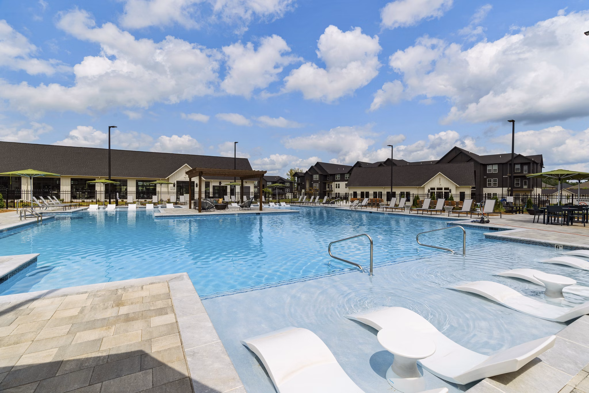 Resort-style pool with sun loungers at The Gabriel Apartments, luxury living in the heart of the city