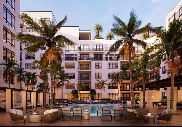 Aster & Links Apartments: Modern pool with lounging areas and lush landscaping