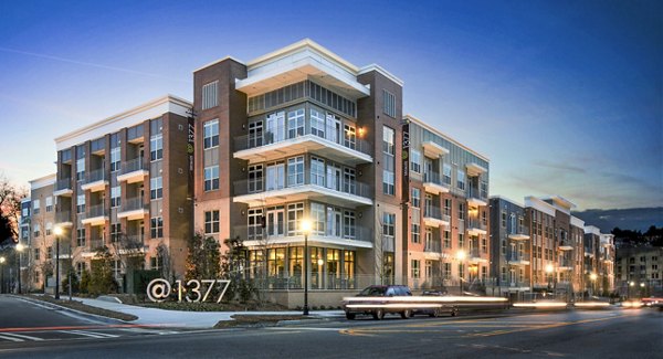 1377: Modern urban mid-rise apartments in a lively neighborhood, featuring sleek architecture and vibrant surroundings