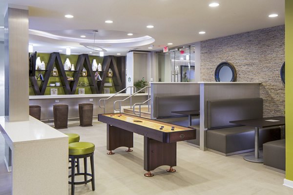 Clubhouse game room featuring pool table and lounge seating at 1377 Apartments Perfect for residents seeking entertainment and relaxation