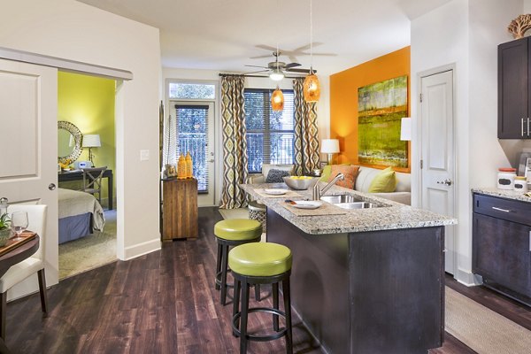Modern kitchen with stainless steel appliances at 1377 Apartments