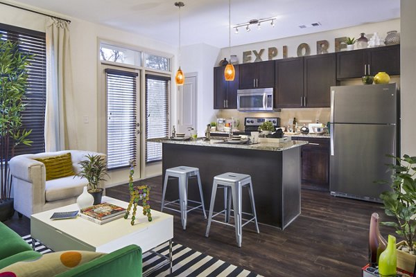 Modern kitchen with stainless steel appliances at 1377 Apartments