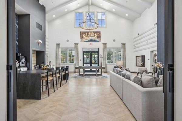 Clubhouse at 4000 Margaret Apartments featuring modern lounge areas and gaming stations