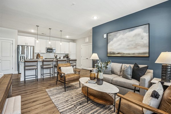 Spacious living room with modern decor in 4000 Margaret Apartments, offering luxury living in a premium setting