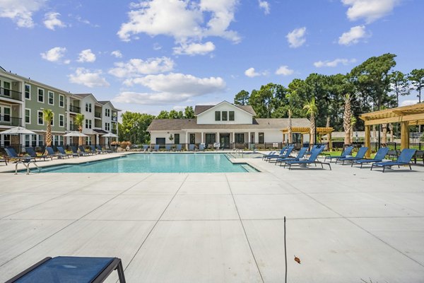 Inviting outdoor pool area at 4000 Margaret Apartments, featuring modern lounge seating and lush landscaping for a luxurious living experience