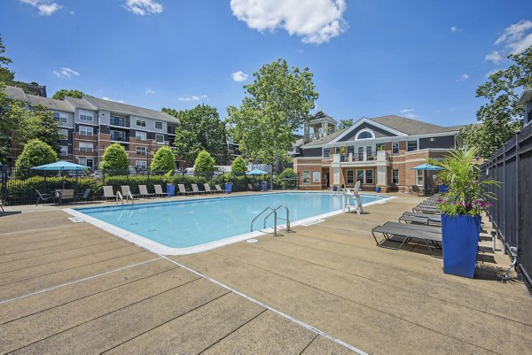 Resort-style pool at Columbia Crossing Apartments with spacious sundeck and lush landscaping