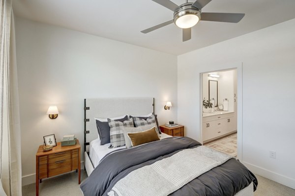 The Taylor at Greenway Apartments: Cozy bedroom with elegant decor and ample natural light