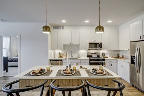 The Taylor at Greenway Apartments: Modern kitchen with sleek countertops and stainless-steel appliances