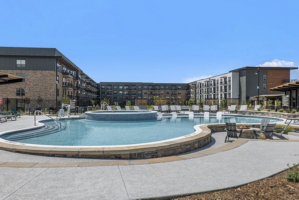 Luxurious outdoor pool at The Taylor at Greenway Apartments with sun loungers