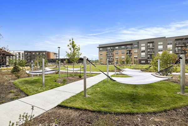 Outdoor courtyard with modern seating and lush greenery at The Taylor at Greenway luxury apartments