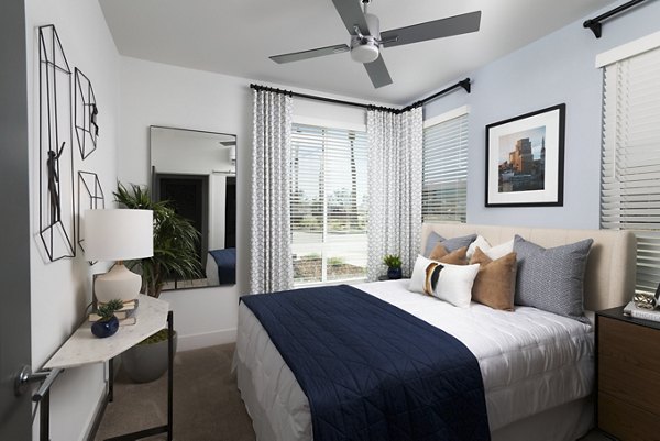 Cozy bedroom with modern decor at The Eisley Apartments, a luxury Greystar community in Sacramento